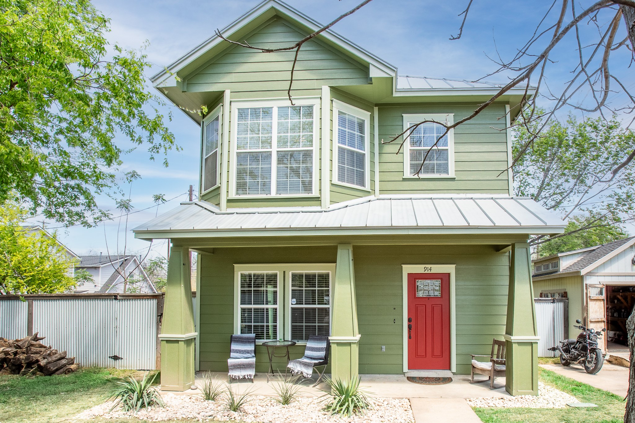 914 Bret Lane Austin, TX 78721 - Photo 2 of 33 a view of a brick house with potted plants and a table and chairs