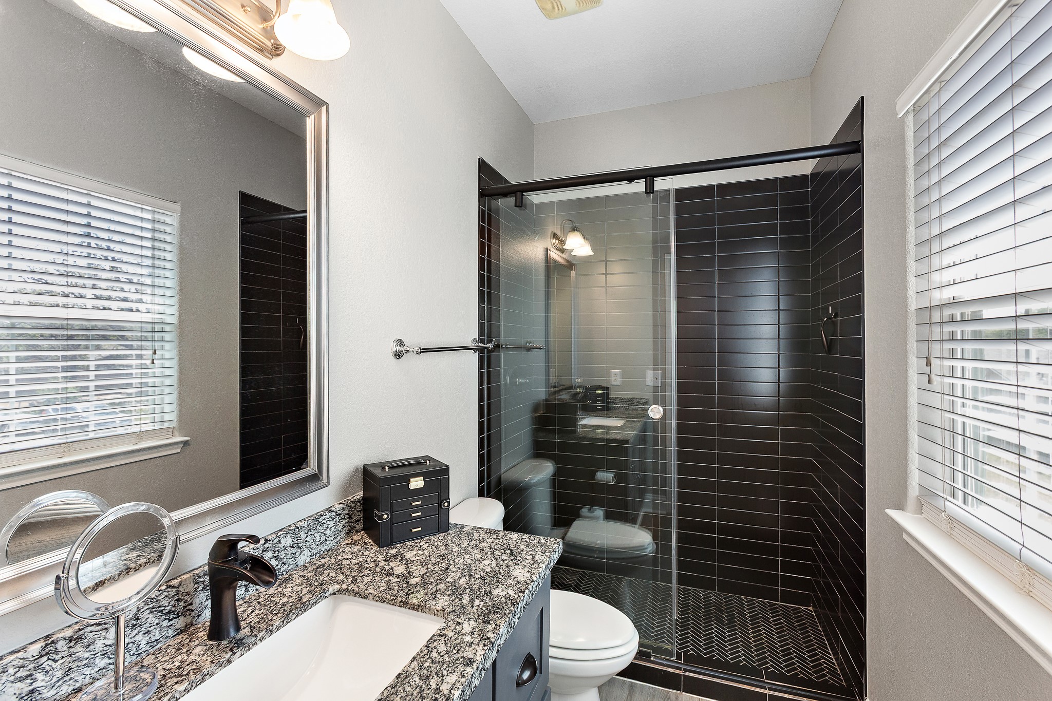 914 Bret Lane Austin, TX 78721 - Photo 21 of 34 a bathroom with a granite countertop sink toilet and shower