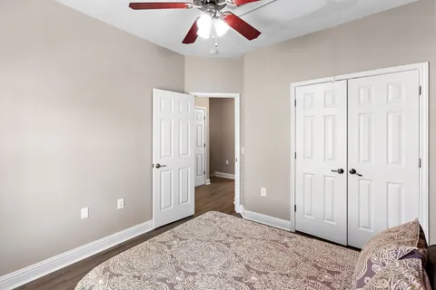 wooden floor in an empty room with a ceiling fan
