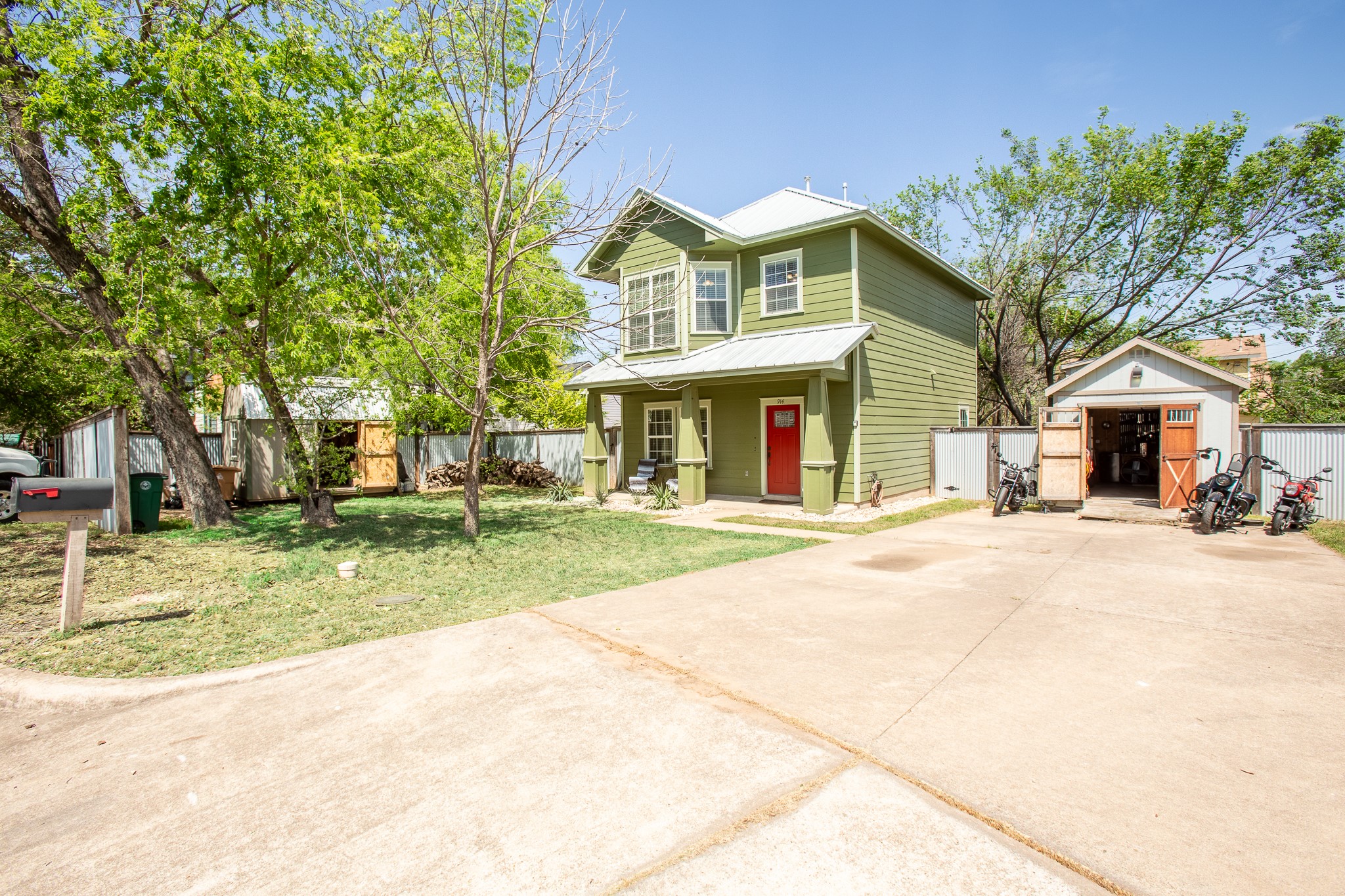 914 Bret Lane Austin, TX 78721 - Photo 4 of 33 a front view of a house with a yard garage and outdoor seating