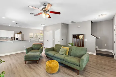 a living room with furniture and kitchen view