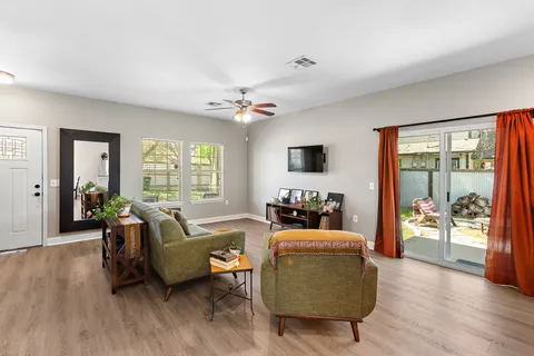 a living room with furniture fireplace and wooden floor