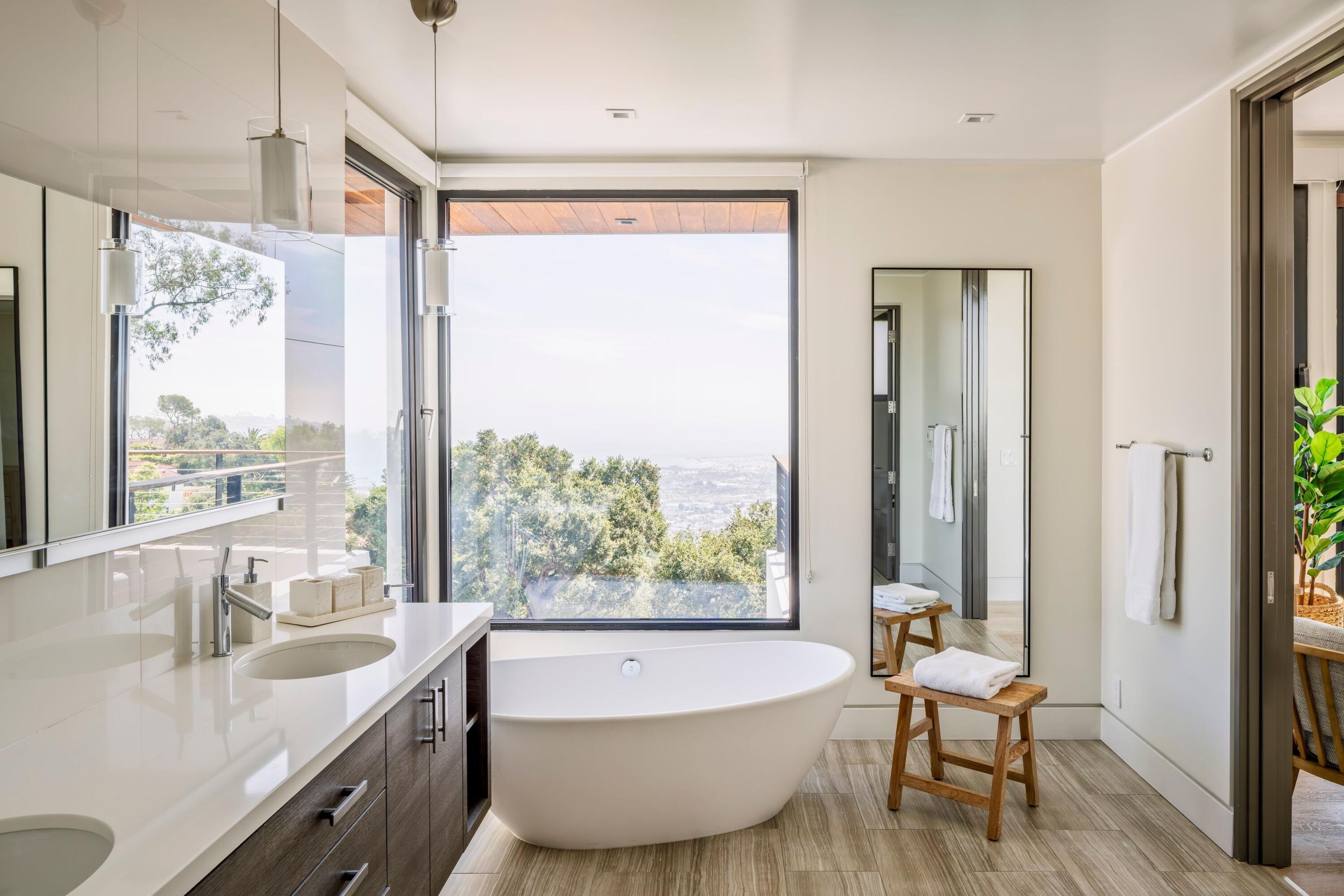 1131 Las Alturas Road, Unit A Santa Barbara, CA 93103 - Photo 18 of 47 a bathroom with a large tub a sink and a large window