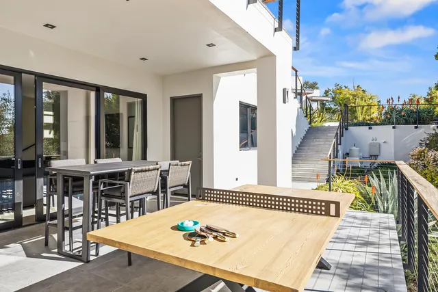 a balcony with furniture and a potted plant