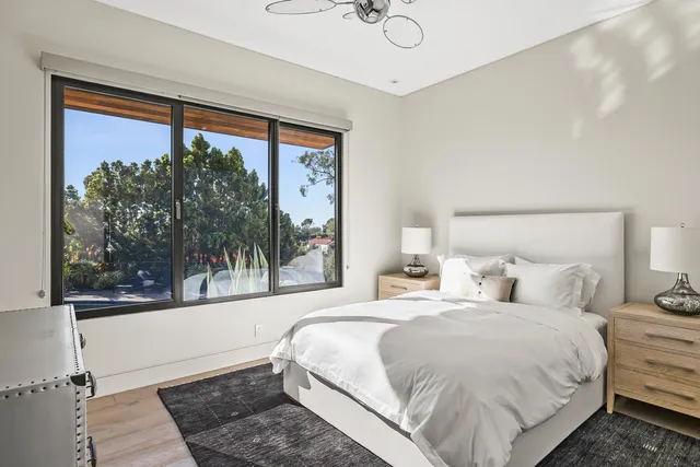 a bedroom with a large bed and a window