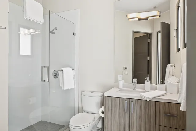 a bathroom with a sink toilet and shower
