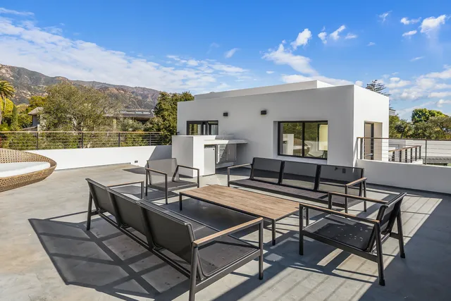 a building outdoor space with patio furniture and a potted plants