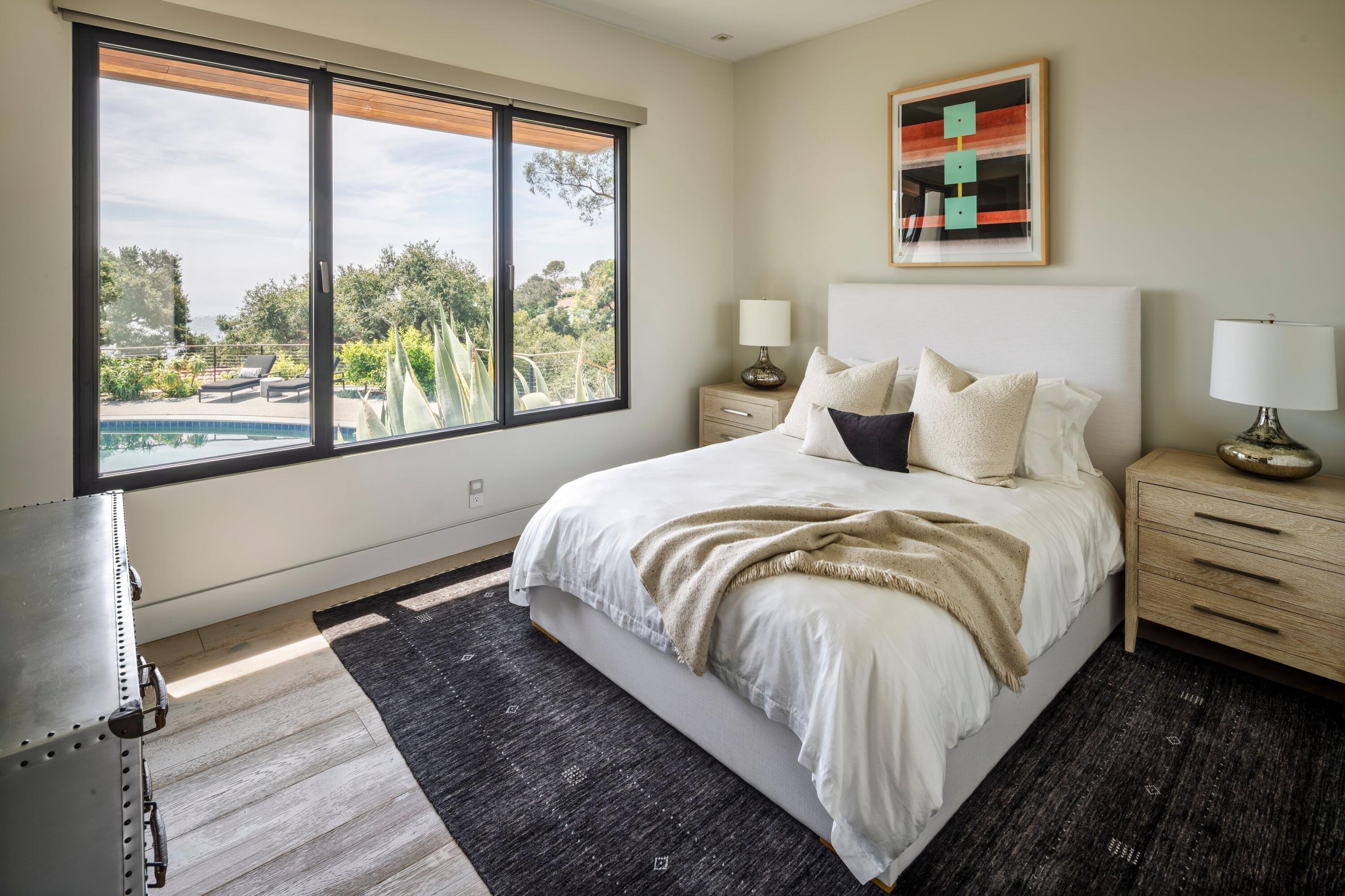 1131 Las Alturas Road, Unit A Santa Barbara, CA 93103 - Photo 26 of 47 a large bed sitting in a bedroom next to a window