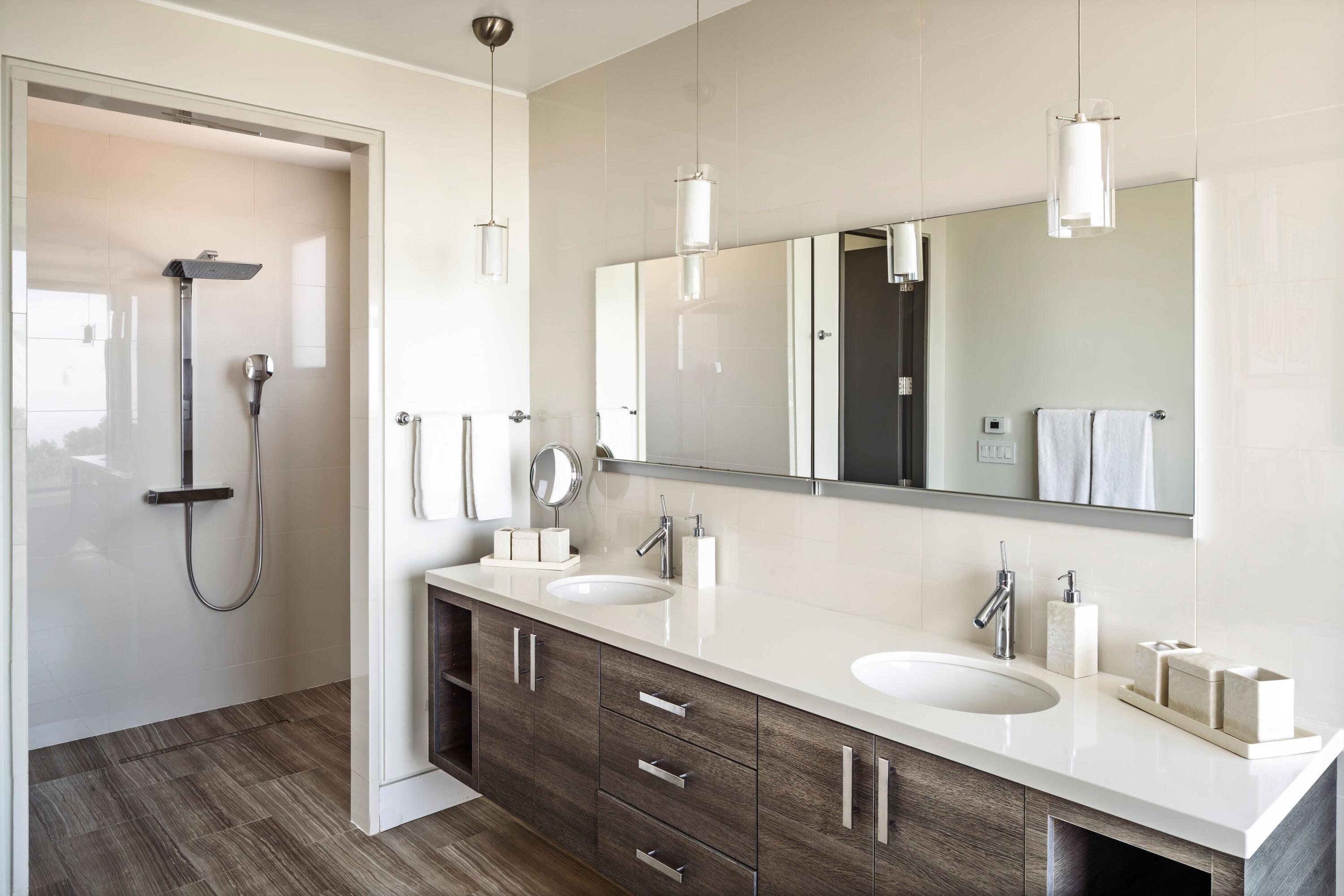 1131 Las Alturas Road, Unit A Santa Barbara, CA 93103 - Photo 29 of 47 a bathroom with a double vanity sink a mirror and a shower