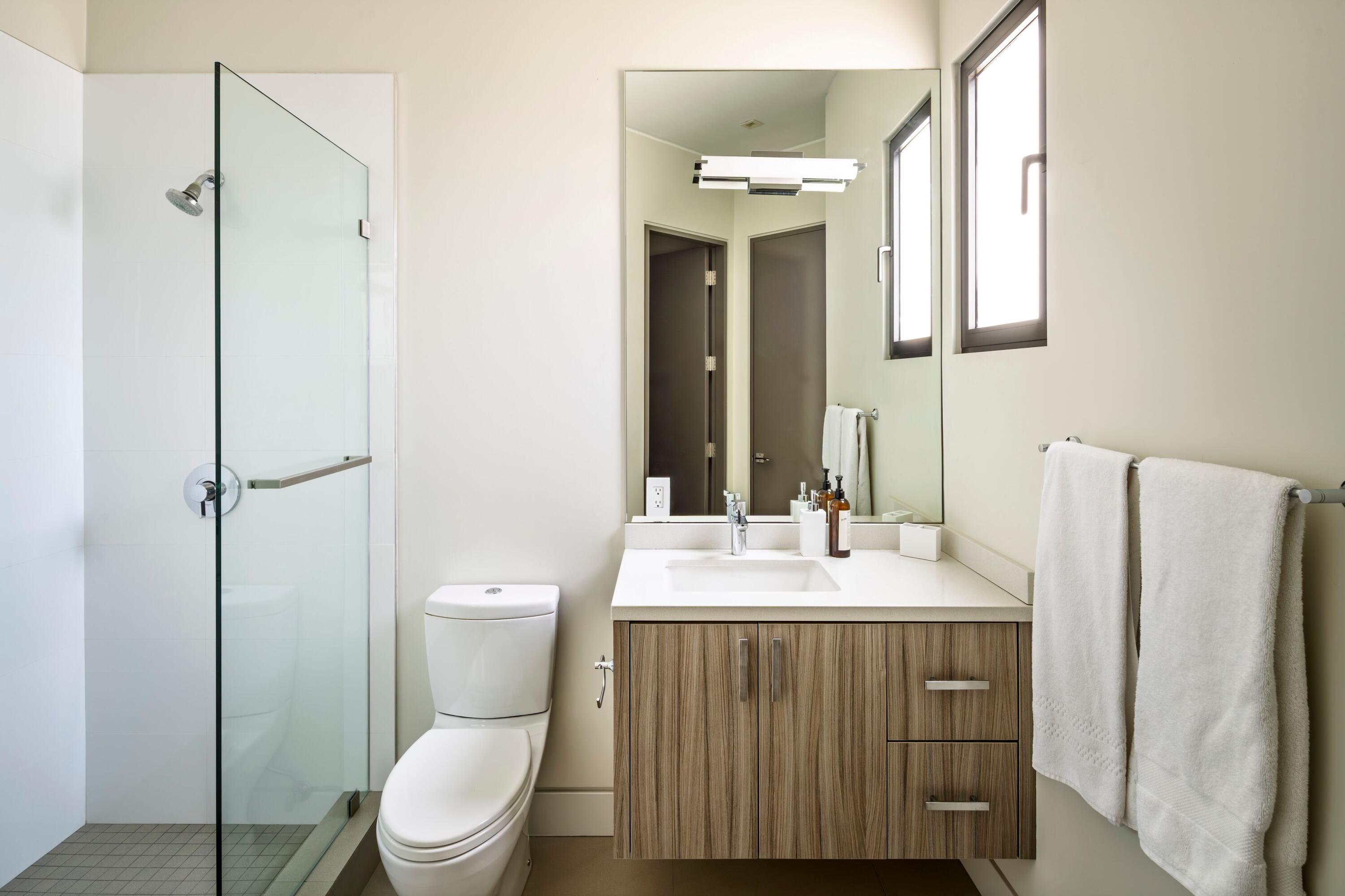 1131 Las Alturas Road, Unit A Santa Barbara, CA 93103 - Photo 31 of 47 a bathroom with a toilet sink vanity and mirror
