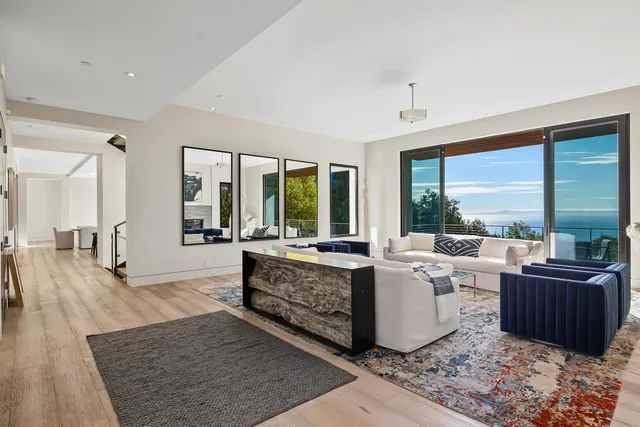 a living room with furniture and large windows