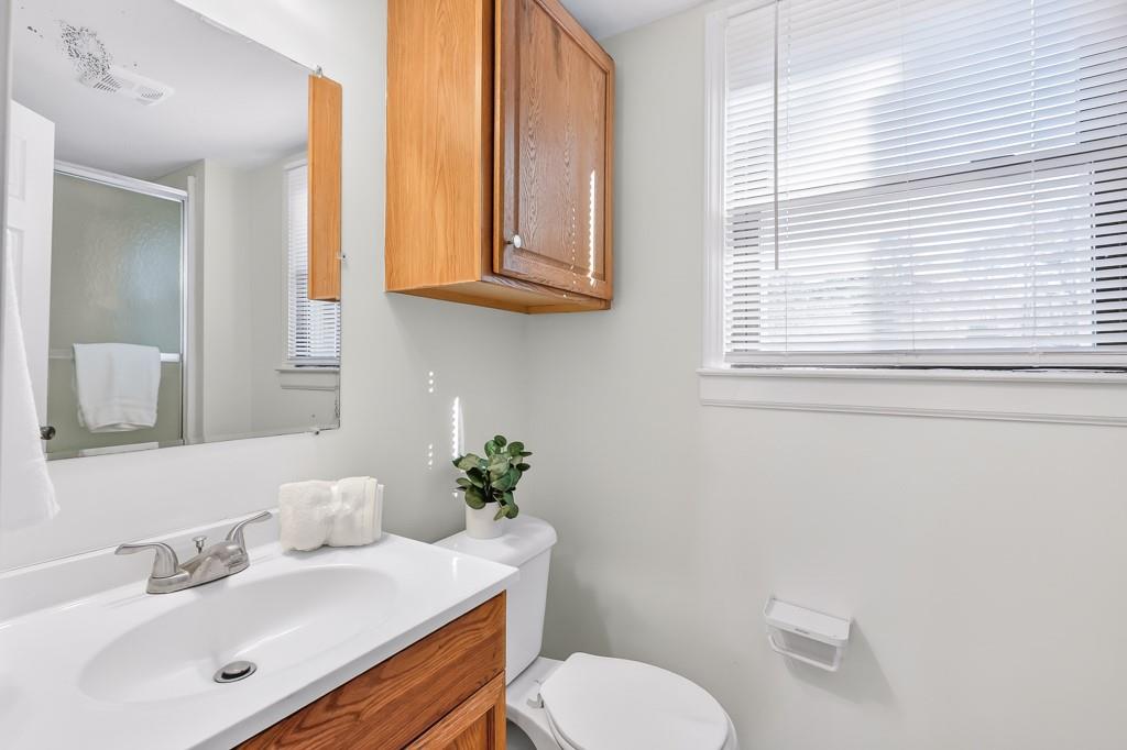 4703 North Springs Road Northwest Kennesaw, GA 30144 - Photo 25 of 35 a bathroom with a sink toilet and mirror