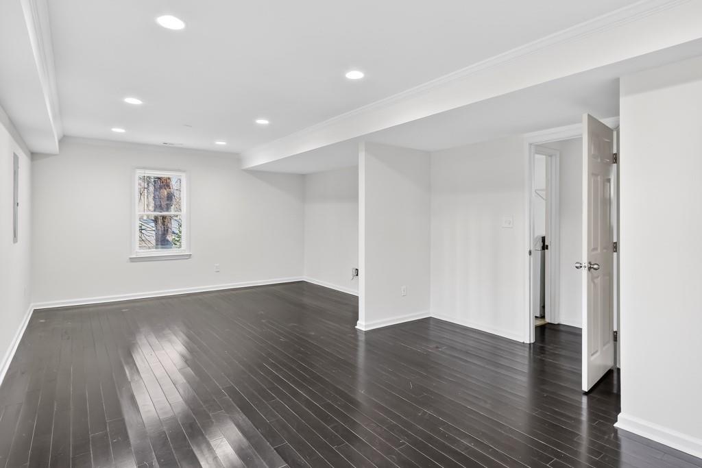 4703 North Springs Road Northwest Kennesaw, GA 30144 - Photo 30 of 35 an empty room with wooden floor and windows