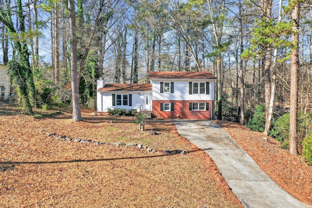 4703 North Springs Road Northwest Kennesaw, GA 30144 - Photo 3 of 35 a view of a house with a yard
