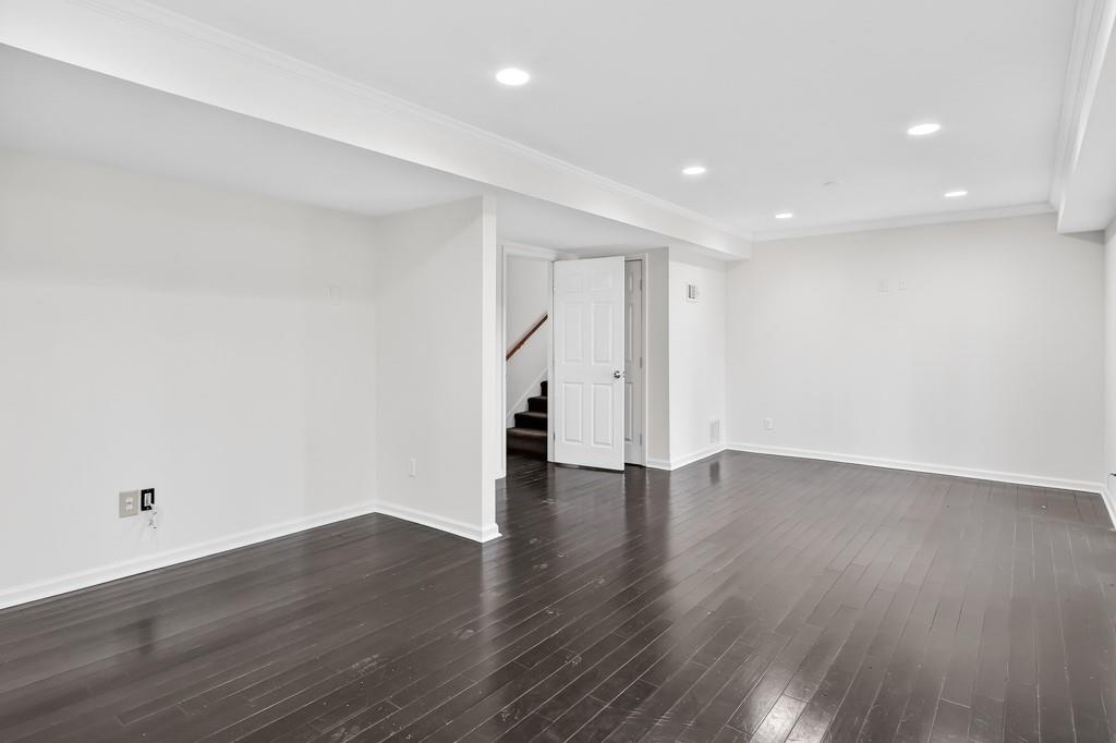 4703 North Springs Road Northwest Kennesaw, GA 30144 - Photo 31 of 35 a view of an empty room with wooden floor and window