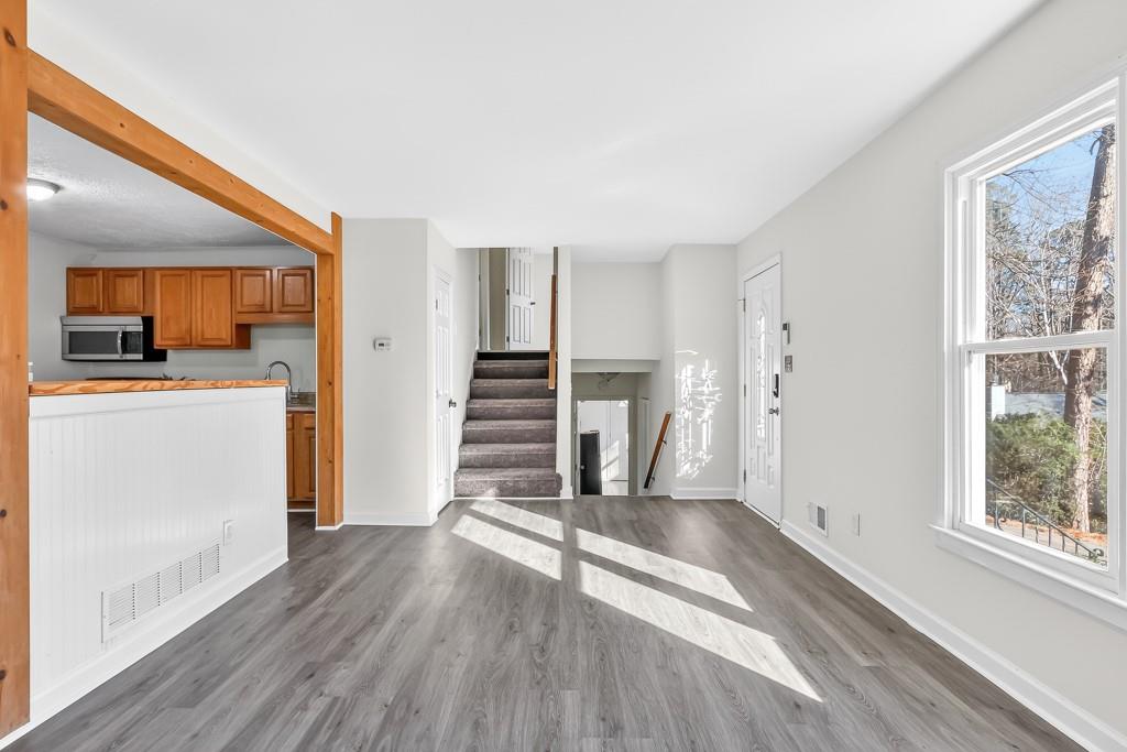 4703 North Springs Road Northwest Kennesaw, GA 30144 - Photo 5 of 35 a view of a kitchen with wooden floor and electronic appliances
