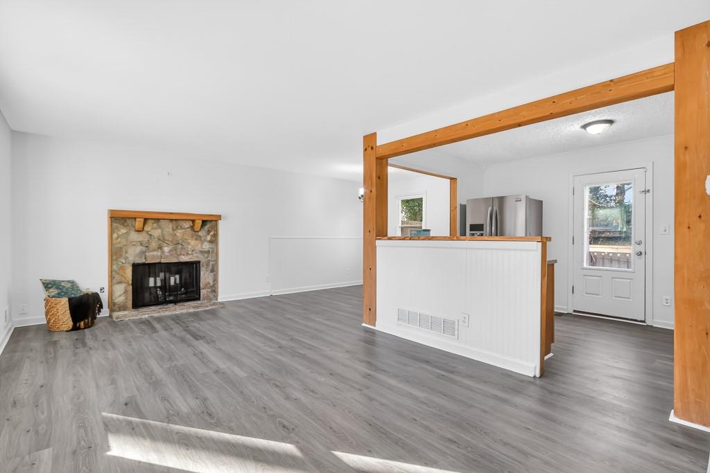 4703 North Springs Road Northwest Kennesaw, GA 30144 - Photo 6 of 35 a view of a livingroom with wooden floor and a fireplace