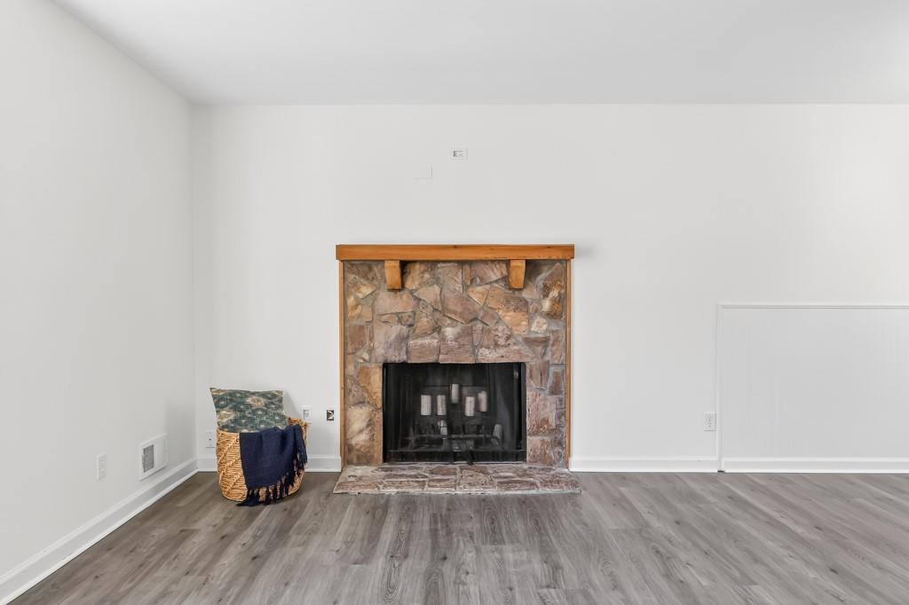 4703 North Springs Road Northwest Kennesaw, GA 30144 - Photo 8 of 35 a room with fireplace and wooden floor