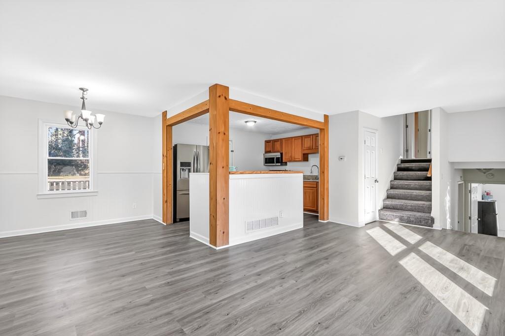 4703 North Springs Road Northwest Kennesaw, GA 30144 - Photo 9 of 35 a view of a kitchen with wooden floor and stairs