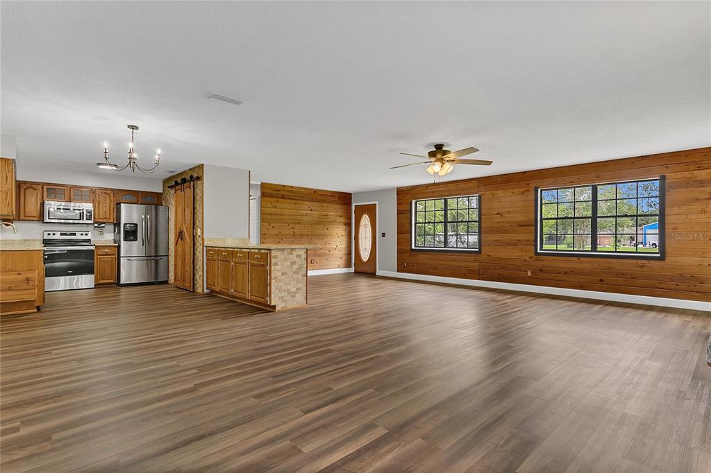 9 Sunny Road Ormond Beach, FL 32174 - Photo 13 of 33 a view of an empty room with a window and wooden floor