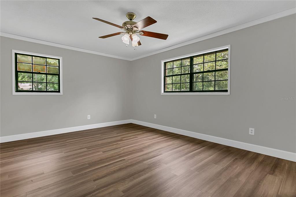 9 Sunny Road Ormond Beach, FL 32174 - Photo 17 of 33 a view of an empty room with wooden floor and a window