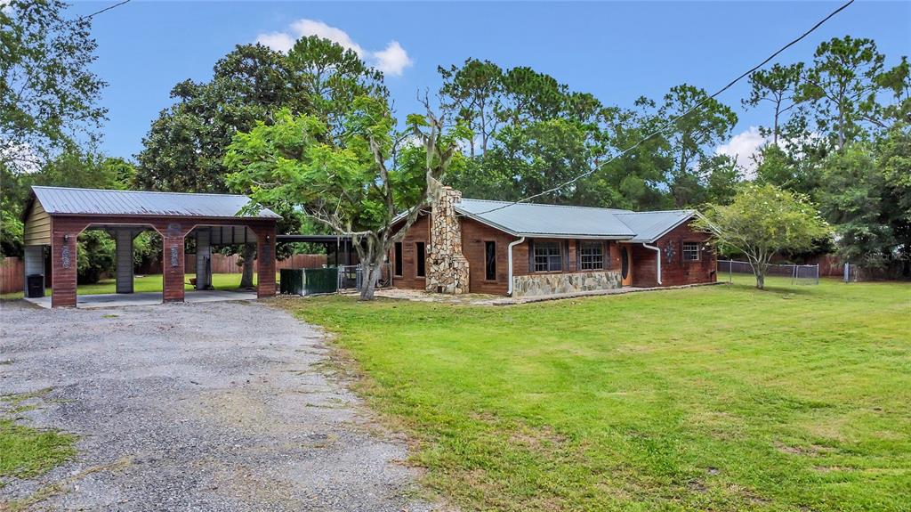 9 Sunny Road Ormond Beach, FL 32174 - Photo 30 of 33 a front view of a house with a garden