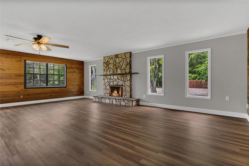 9 Sunny Road Ormond Beach, FL 32174 - Photo 3 of 33 a view of empty room with fireplace and wooden floor