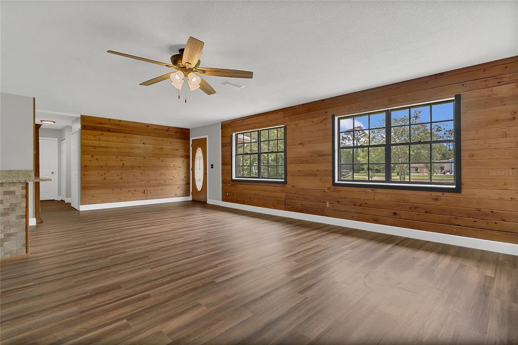 9 Sunny Road Ormond Beach, FL 32174 - Photo 10 of 33 a view of an empty room with a window and wooden floor