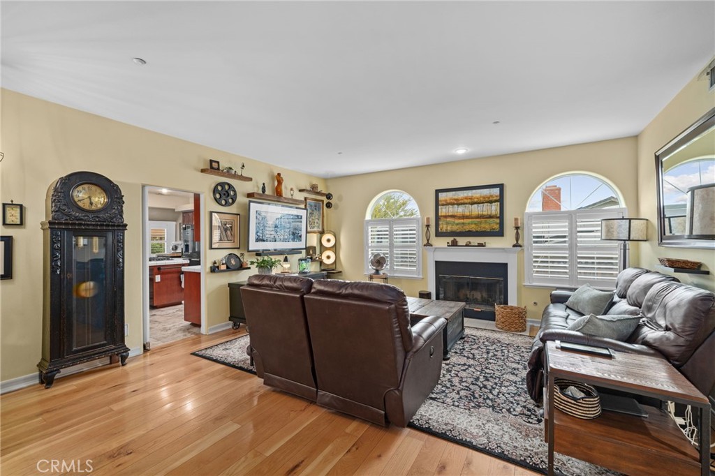 334 Lakeside Avenue Redlands, CA 92373 - Photo 12 of 63 a living room with fireplace furniture and a wooden floor