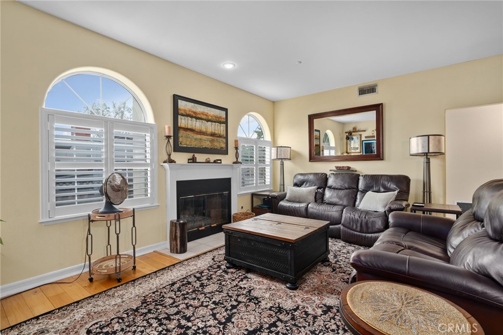 334 Lakeside Avenue Redlands, CA 92373 - Photo 13 of 63 a living room with furniture a fireplace and wall paintings