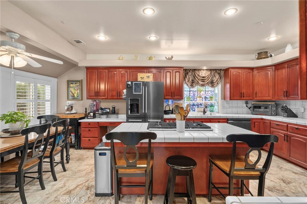 334 Lakeside Avenue Redlands, CA 92373 - Photo 17 of 63 a kitchen with stainless steel appliances granite countertop a stove a sink a table and chairs