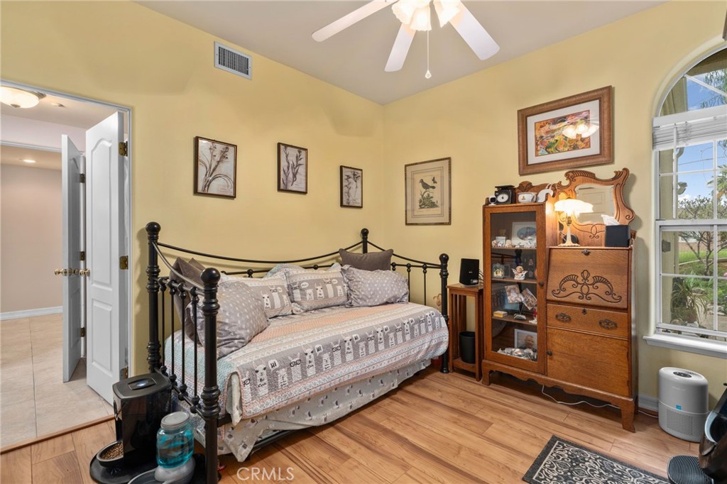 334 Lakeside Avenue Redlands, CA 92373 - Photo 18 of 63 a bedroom with a bed chandelier and a window