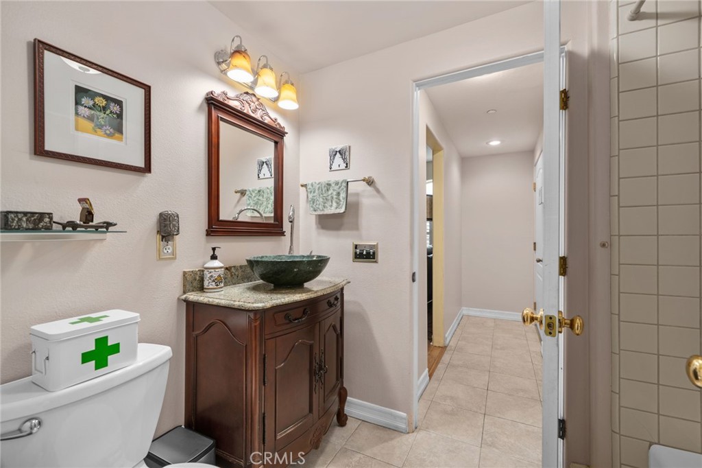 334 Lakeside Avenue Redlands, CA 92373 - Photo 20 of 63 a bathroom with a granite countertop sink a toilet and mirror