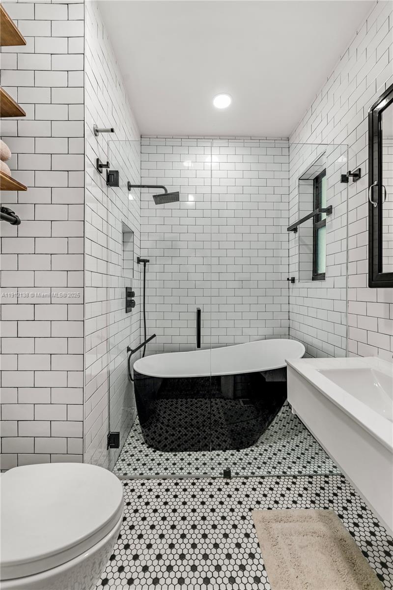 1601 Washington Street Hollywood, FL 33020 - Photo 15 of 41 a bathroom with a sink a toilet and shower