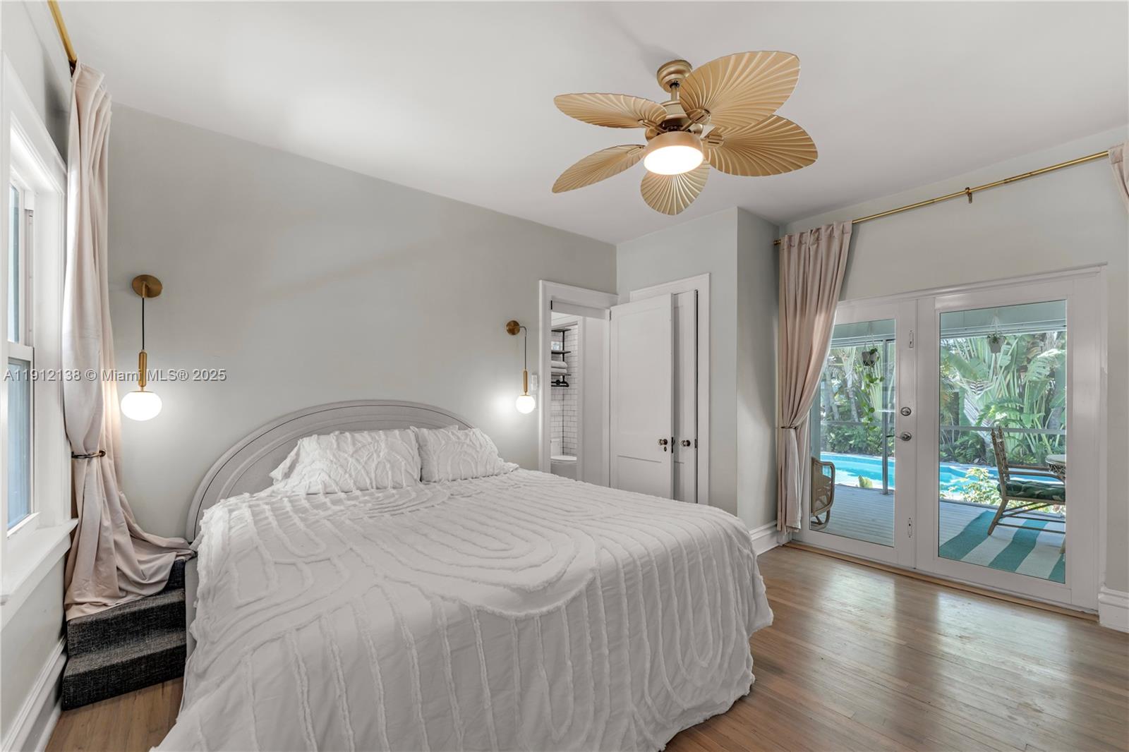 1601 Washington Street Hollywood, FL 33020 - Photo 17 of 41 a bedroom with a bed and a chandelier