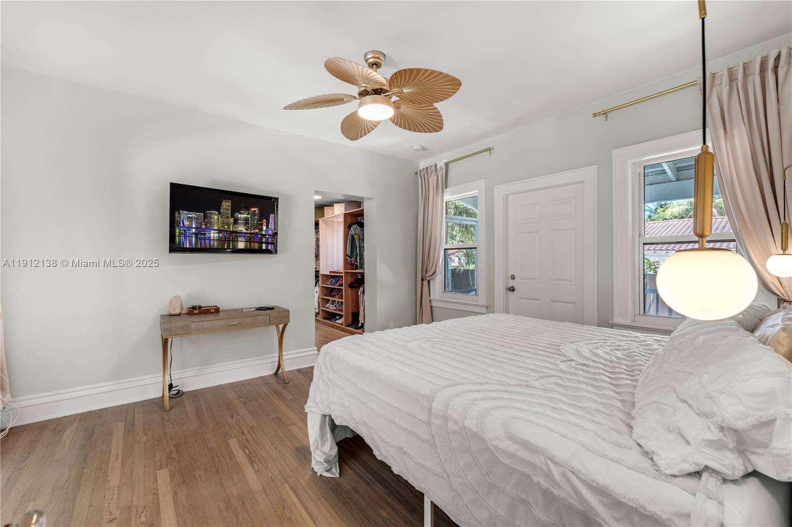 1601 Washington Street Hollywood, FL 33020 - Photo 18 of 41 a bedroom with a bed and a chandelier