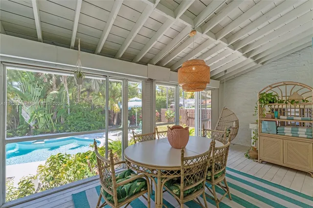 a outdoor dining space with furniture and wooden floor