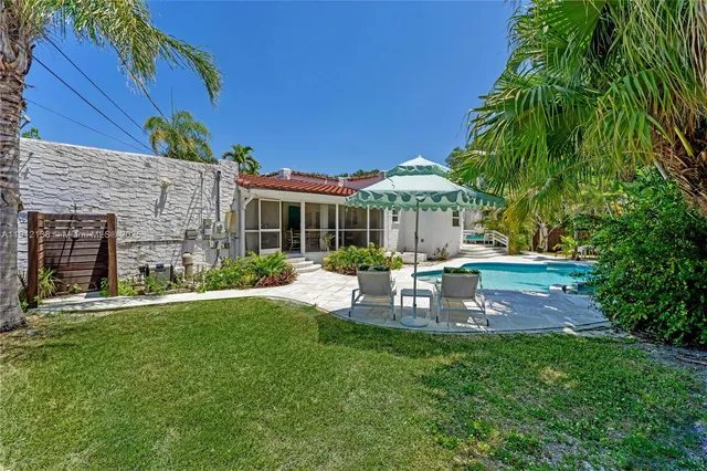 a backyard of a house with table and chairs