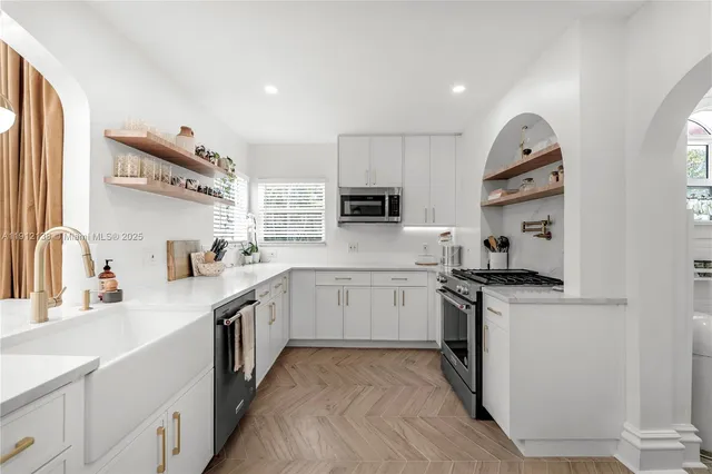 a kitchen with granite countertop a sink stove and refrigerator