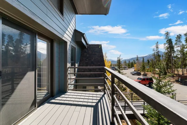 a view of balcony with wooden floor and fence
