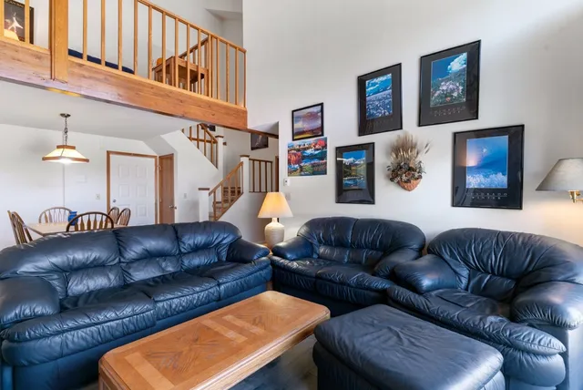 a living room with furniture a couch and a bookshelf