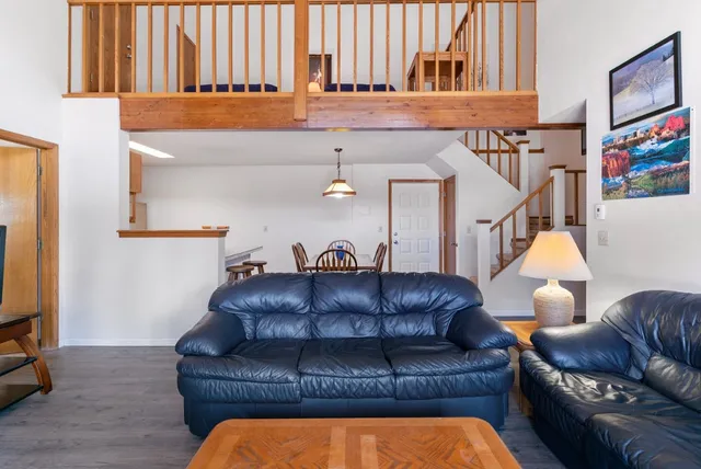 a living room with furniture and a lamp