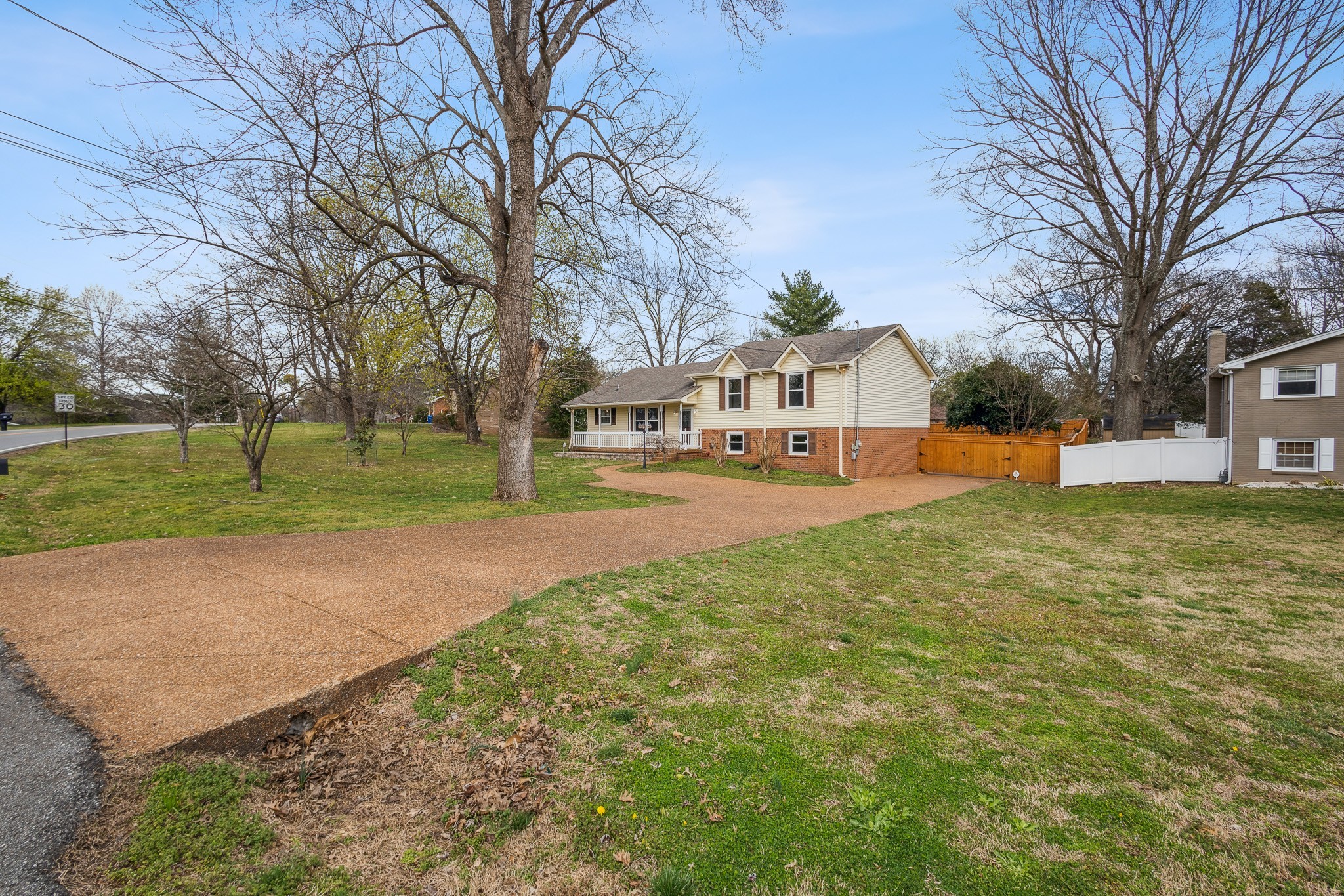 195 Cherokee Road Hendersonville, TN 37075 - Photo 51 of 61 a front view of a house with a yard and trees
