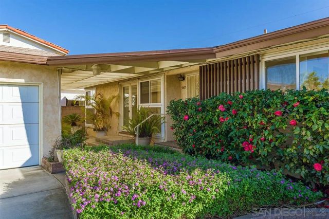 a view of a house with a flower garden