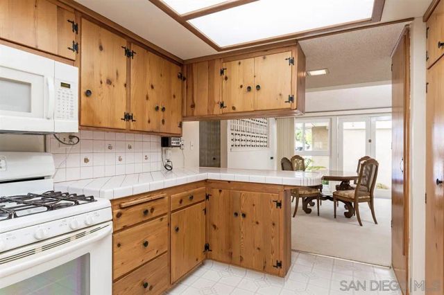a kitchen with cabinets appliances and a window