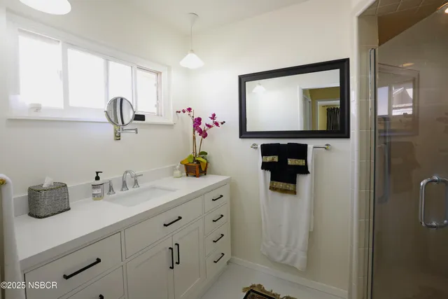 a bathroom with a sink vanity and mirror