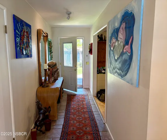 a entryway with furniture and wooden floor