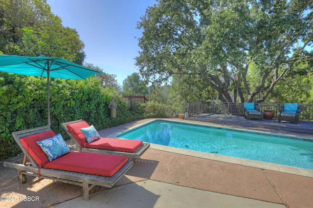 a backyard of a house with table and chairs