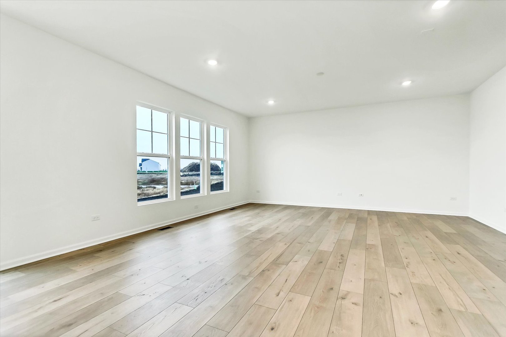 17350 Victoria Lane Lockport, IL 60441 - Photo 5 of 29 an empty room with wooden floor and windows