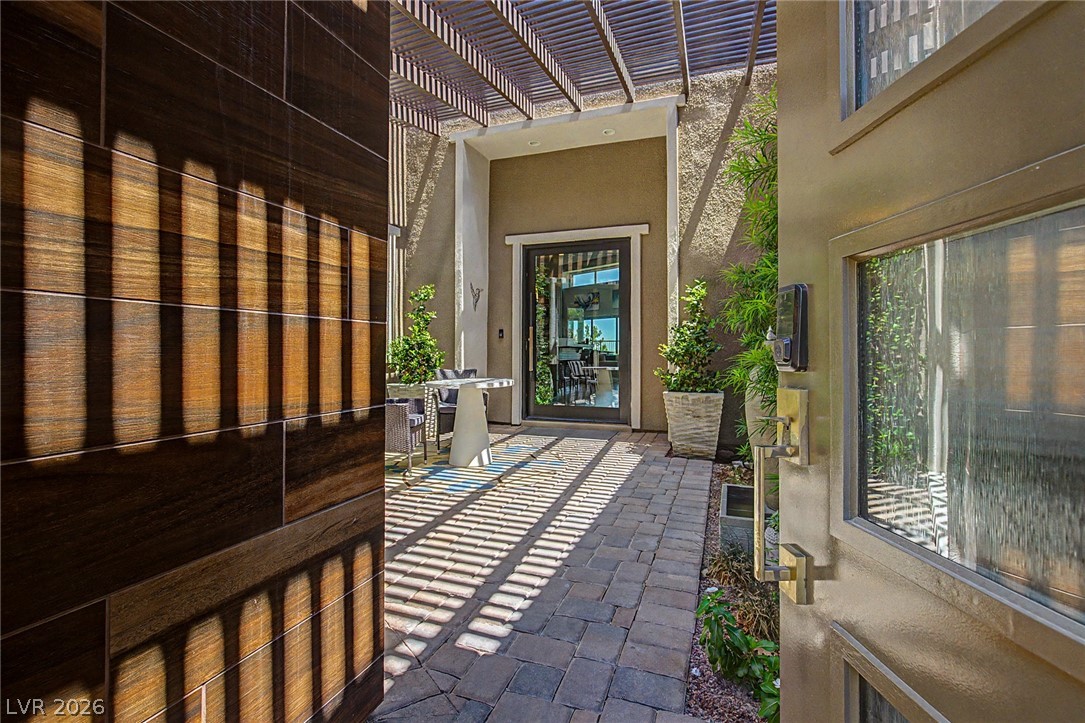 6014 Willow Ridge Court Las Vegas, NV 89135 - Photo 6 of 99 An inviting entrance with a paver walkway leads to a modern front door, perfect for welcoming guests.